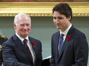 Prime Minister Justin Trudeau shakes hands with then-Governor General David Johnston.