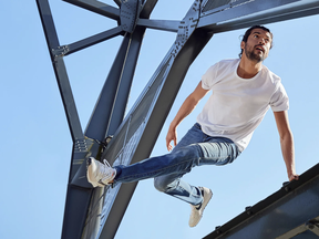 man jumping off bridge in jeans