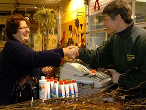 Sue Barnes, left, shakes hands in London, Ont.