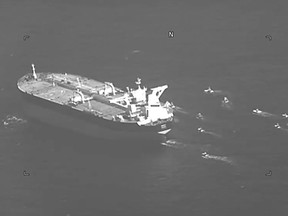 This still image from video released by the U.S. Navy shows the Panama-flagged oil tanker Niovi surrounded by Iranian Revolutionary Guard vessels in the Strait of Hormuz Wednesday, May 3, 2023. Iran seized a Panama-flagged oil tanker in the Strait of Hormuz on Wednesday, the second-such capture by Tehran in recent days, the U.S. Navy said. (U.S. Navy via AP)