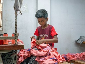 A child labourer working in a local garment factory in Dhaka, Bangladesh on February 28, 2023.