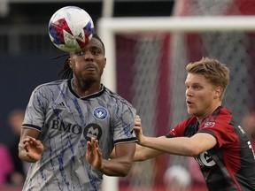CF Montreal's Chinonso Offor (left) shields the ball from Toronto FC's Sigurd Rosted during first half Canadian Championship quarterfinal action in Toronto on Tuesday, May 9, 2023.THE CANADIAN PRESS/Chris Young