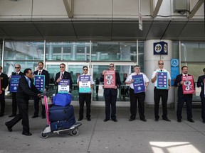 WestJet Airlines pilots stand on a picket line at Toronto's Pearson Airport on Monday May 8, 2023.