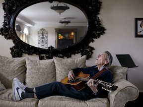 Canadian musician Gordon Lightfoot strums his guitar in his Toronto home on April 25, 2019.