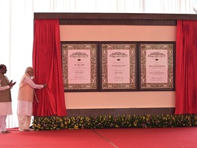 Indian prime minister Narendra Modi, second left, inaugurates the new parliament building as speaker of the lower house Om Birla watches, in New Delhi, India, Sunday, 28 May 2023. The new triangular parliament building, built at an estimated cost of $120 million, is part of a $2.8 billion revamp of British-era offices and residences in central New Delhi called "Central Vista", even as India's major opposition parties boycotted the inauguration, in a rare show of unity against the Hindu nationalist ruling party that has completed nine years in power and is seeking a third term in crucial general elections next year. (AP Photo)