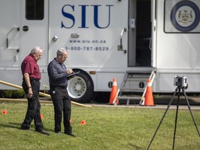 Officers in Hamilton inspect the site of double homicide