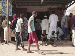 People line up in front of a bakery during a cease-fire in Khartoum, Sudan, Saturday, May 27, 2023. Saudi Arabia and the United States say the warring parties in Sudan are adhering better to a week-long cease-fire after days of fighting.