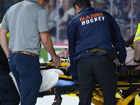 Kamloops Blazers' Kyle Masters is taken off the ice on a stretcher after a collision with Peterborough Petes' Brennan Othmann during third period Memorial Cup hockey action in Kamloops, B.C. on Sunday, May 28, 2023.