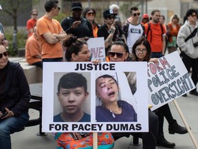 People gather and take part in a protest for Pacey Dumas, an Indigenous young man who was kicked in the head by a police officer in 2020, in Edmonton on Saturday May 6, 2023.