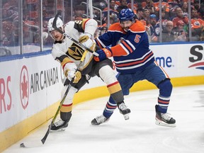 Vegas Golden Knights' Jack Eichel (9) and Edmonton Oilers' Cody Ceci (5) battle for the puck during first period NHL Stanley Cup second round playoff action in Edmonton on Monday May 8, 2023.