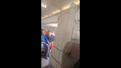 A video shared on social media shows passengers’ hair being whipped by air blowing into the cabin. Clip created by Giphy.