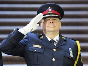 Then-incoming Toronto Police Chief Myron Demkiw salutes during the playing of the national anthem at a change of command ceremony in Toronto, on Dec.19, 2022. Officials with a national program intended to enlist public help in arresting Canada's most wanted fugitives are expected to make an announcement in Toronto this morning.