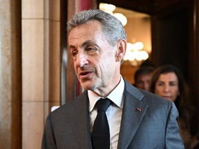 Former French President Nicolas Sarkozy leaves the courthouse after the ruling in his appeal trial in a corruption case at Paris courthouse on May 17, 2023.