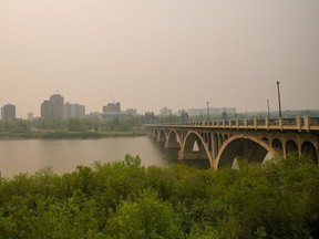 University Bridge is photographed through thick smoke from wildfires burning across the Prairies, in Saskatoon, Sask., on Saturday, May 20, 2023.