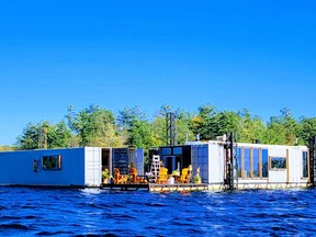 Nimens’ floating home made from four shipping containers is moved by tugboat from spot to spot. (Photo courtsey Live on the Bay)