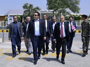 In this photo released by Pakistan's Foreign Ministry, Foreign Minister Bilawal Bhutto Zardari, third left, walks with other officials toward his plane to depart for India, in Karachi, Pakistan, Thursday, May 4, 2023. Bhutto departs for India to attend the meeting of Shanghai Cooperation Organization's foreign ministers being held in neighboring India's state of Goa. (Pakistan Foreign Ministry via AP)