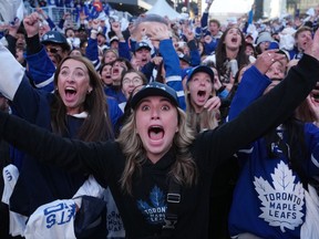 Fans in Maple Leaf Square celebrate the first goal by the Toronto Maple Leafs against the Tampa Bay Lightning during first period NHL Stanley Cup playoff hockey action in Toronto on Thursday, April 27, 2023.