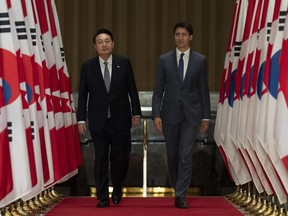 Canadian Prime Minister Justin Trudeau and South Korean President Yoon Suk Yeol walk to a joint news conference in Ottawa on Friday, Sept. 23, 2022.