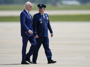 President Joe Biden, escorted by 89th Airlift Wing Commander, Air Force Col. Matthew Jones, walks to board Air Force One at Andrews Air Force Base, Md., Wednesday, May 17, 2023, as he heads to Hiroshima, Japan to attend the G-7.