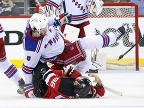 Jacob Trouba #8 of the New York Rangers hits Timo Meier #96 of the New Jersey Devils during the third period in Game Seven of the First Round of the 2023 Stanley Cup Playoffs at Prudential Center on May 01, 2023 in Newark, New Jersey.
