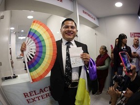 Jesus Ociel Baena, who identifies as non-binary person, poses for a photo after receiving the non-binary passport during the International Day Against Homophobia, Transphobia and Biphobia, in Mexico City, Mexico May 17, 2023.