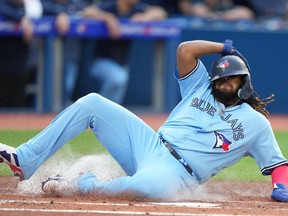 Toronto Blue Jays first baseman Vladimir Guerrero Jr. (27) slides into homeplate to score during first inning Interleague MLB baseball action against the Milwaukee Brewers in Toronto on Tuesday, May 30, 2023.
