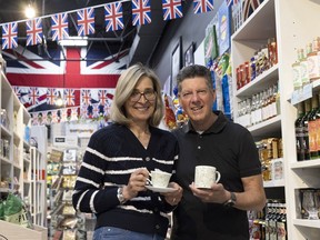 Rita and Carl Hulme stand with King Charles merchandise at Blimeys British Store and Gift Shop in Essex, Ont. on Sunday, April 16, 2023.