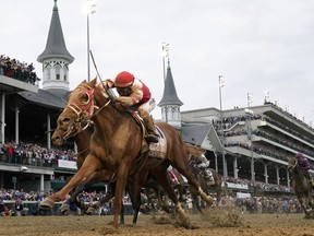 FILE - Rich Strike, with Sonny Leon aboard, crosses the finish line to win the 148th running of the Kentucky Derby horse race at Churchill Downs Saturday, May 7, 2022, in Louisville, Ky. Rich Strike's stunning upset victory in last year's Kentucky Derby as a nearly 81-1 long shot provided the race's second biggest odds winner in four years.