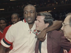 FILE - Louisville's Robbie Vallentin hugs coach Denny Crum after beating Auburn 84-76 for the West NCAA Championship in Houston, March 21, 1986. Denny Crum, who won two NCAA men's basketball championships and built Louisville into one of the 1980s' dominant programs during a Hall of Fame coaching career, died Tuesday, May 9, 2023. He was 86.