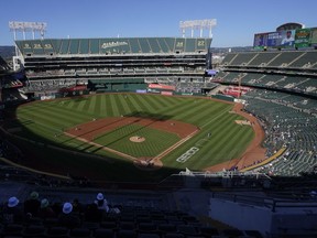 People watch a baseball game at Oakland Coliseum between the Oakland Athletics and the Texas Rangers in Oakland, Calif., July 23, 2022.
