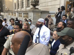 FILE - Adnan Syed, center, leaves the Elijah E. Cummings Courthouse on Sept. 19, 2022, in Baltimore. Syed's lawyer has asked Maryland's highest court Wednesday, May 24, 2023, to overturn a lower court's ruling that reinstated his murder conviction from more than two decades ago - after he was freed last year in a legal case that gained international attention from the hit podcast "Serial."