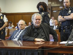 Steve Bannon, center, appears in Manhattan Supreme Court, Thursday, May 25, 2023 in New York. Bannon, the conservative strategist, will stand trial next May on charges he duped donors who gave money to build a wall on the U.S.-Mexico border, a judge in New York said Thursday.