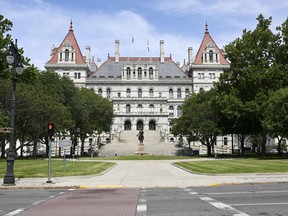 FILE - The New York state Capitol is pictured, June 30, 2022, in Albany, N.Y. New York lawmakers began voting Monday, May 1, 2023, on a $229 billion state budget due a month ago that would raise the minimum wage, alter the bail law and ban gas stoves and furnaces in new buildings.