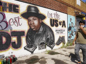 FILE - A pedestrian passes a mural of rap pioneer Jam Master Jay of Run-DMC, by artist Art1Airbrush, Aug. 18, 2020, in the Queens borough of New York. A third man has been charged in the 2002 shooting death of hip-hop trailblazer Jam Master Jay, prosecutors said Tuesday, May 30, 2023, adding another suspect in the Run-DMC member's killing which for years after it initially happened had languished as a cold case.