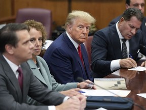 FILE - Former President Donald Trump sits at the defense table with his legal team in a Manhattan court, April 4, 2023, in New York. Ten months before Trump is scheduled to stand trial in his historic New York City criminal case, Manhattan prosecutors are in a tug of war with the former president's legal team over precisely where he will be tried. Trump's lawyers are angling to have the hush-money case moved to federal court while the Manhattan district attorney's office, in court papers Tuesday, May 30, says it should remain in the state court where it originated.