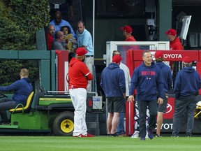 A fan, who fell into the Boston Red Sox bullpen, is brought down by the medical staff during the first inning of a baseball game against the Philadelphia Phillies, Friday, May 5, 2023, in Philadelphia.
