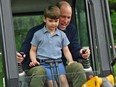 Prince William, Prince of Wales, is helped by his son Prince Louis as he uses an excavator while taking part in the Big Help Out, during a visit to the 3rd Upton Scouts Hut in London, England, on May 8, 2023.