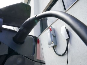 An electric vehicle is charged in Ottawa on Wednesday, July 13, 2022. Canada and the U.S. are teaming up to build a corridor of charging stations between Quebec City and Michigan to encourage motorists in both countries to buy more electric vehicles.THE CANADIAN PRESS/Sean Kilpatrick