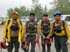 A crewsfrom the Government of the Northwest Territories and Parks Canada in Fort Smith head out on the line to fight fires on Wednesday, May 24, 2023 in a handout photo.