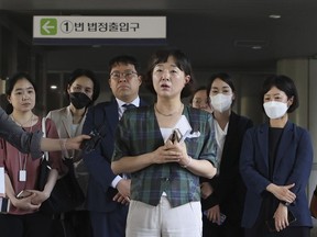 Kim Soo-jung, one of Adam Crapser's lawyers, speaks to the media outside the court at the Seoul Central District Court in Seoul, South Korea, Tuesday, May 16, 2023. A court on Tuesday ordered South Korea's biggest adoption agency to pay 100 million won ($74,700) in damages to Crapser for mishandling his adoption as a child to the United States, where he faced legal troubles after surviving an abusive childhood before being deported in 2016.