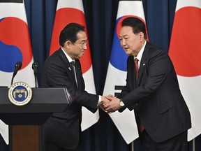 FILE - South Korean President Yoon Suk Yeol, right, shakes hands with Japanese Prime Minister Fumio Kishida during a joint press conference after their meeting at the presidential office in Seoul, May 7, 2023. Amid the high-level efforts to tackle the world's worst crises, this weekend's Group of 7 summit of rich democracies will also see an unusual diplomatic reconciliation as the leaders of Japan and South Korea look to continue mending ties that have been marked for years by animosity and bickering.