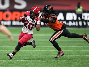 Calgary Stampeders' Peyton Logan (20) is shoved out of bounds by B.C. Lions' Jordan Williams (21) during the first half of CFL football game in Vancouver, on Saturday, September 24, 2022. Williams is preparing for his third CFL season but first with the Toronto Argonauts.
