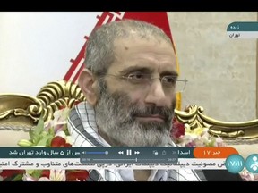 In this frame grab from video footage released Friday, May 26, 2023, by Iran state TV, IRINN, Assadollah Assadi, an Iranian diplomat who was released in a prisoner swap with Belgium, sits upon arrival at the Mehrabad airport in Tehran, Iran. Belgium and Iran exchanged prisoners on Friday in a controversial move that saw an Iranian diplomat convicted of attempting to bomb exiles in France bedecked in flowers on his return to Tehran while an aid worker was heading back to Brussels. (IRINN via AP)