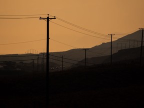 The landscape is dotted with power lines and poles as smoke from wildfires burning in the area fills the air while motorists travel on the Trans-Canada Highway near Walhachin, B.C., on Thursday, July 15, 2021. BC Hydro is expecting potentially record-breaking demand on the power system as the province enters what is forecast to be a blistering heat wave.