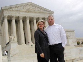 FILE - Michael and Chantell Sackett of Priest Lake, Idaho, pose for a photo in front of the Supreme Court in Washington on Oct. 14, 2011. The Supreme Court on Thursday, May 25, 2023, made it harder for the federal government to police water pollution in a decision that strips protections from wetlands that are isolated from larger bodies of water. The justices boosted property rights over concerns about clean water in a ruling in favor of an Idaho couple who sought to build a house near Priest Lake in the state's panhandle.