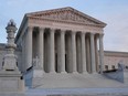 FILE - The setting sun illuminates the Supreme Court building on Capitol Hill in Washington, Jan. 10, 2023.