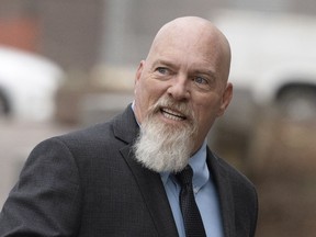 FILE - Richard Barnett, an Arkansas man who was photographed with his feet on a desk in former House Speaker Nancy Pelosi's office during the Jan. 6 U.S. Capitol riot, arrives at federal court in Washington, Jan. 10, 2023. Barnett was sentenced Wednesday, May 24, 2023, to more than four years in prison. U.S. District Judge Christopher Cooper said that Barnett became one of the faces of the Jan. 6 riot, and at times he seemed to enjoy the notoriety.