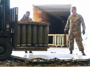 FILE - Airmen with the 436th Aerial Port Squadron place 155 mm shells on aircraft pallets ultimately bound for Ukraine, April 29, 2022, at Dover Air Force Base, Del. Half of the people in the U.S. support the Pentagon's ongoing supply of weapons to Ukraine for its defense against Russian forces. That's according to a new survey by the University of Chicago's Harris School of Public Policy and NORC.
