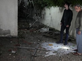 Palestinians inspect damage to their building following Israeli airstrikes at an apartment of an Islamic Jihad commander for northern Gaza, in Gaza City, early Tuesday, May 9, 2023. Israeli aircraft conducted strikes on Islamic Jihad targets in the Gaza Strip, the Israeli military said. The Palestinian Health Ministry said a number of people were killed and injured in the airstrikes.