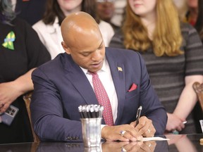 Maryland Gov. Wes Moore signs one of several gun-control measures during a bill-signing ceremony on Tuesday, May 16, 2023, in Annapolis, Md. One of the bills signed by the governor generally prohibits a person from wearing, carrying or transporting a gun into areas like schools or health care facilities.